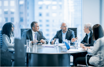 Five people sit around a conference table.